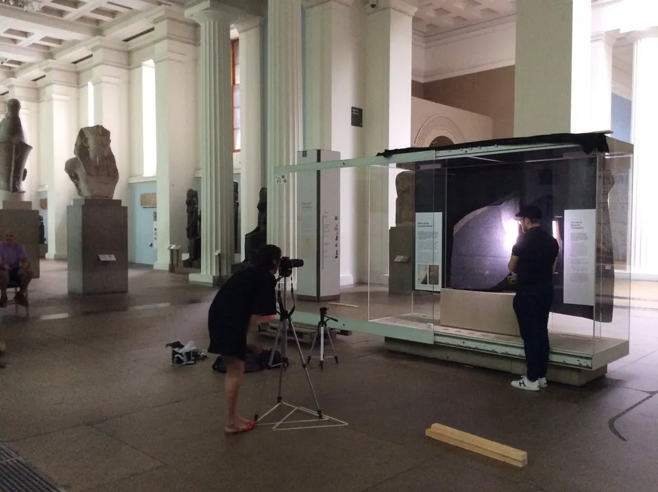 Researchers set up scanning equipment beside the Rosetta Stone’s display case in a British Museum gallery.