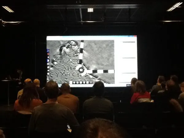 Audience watching a presentation of a 3D inscription viewer with a scale bar.