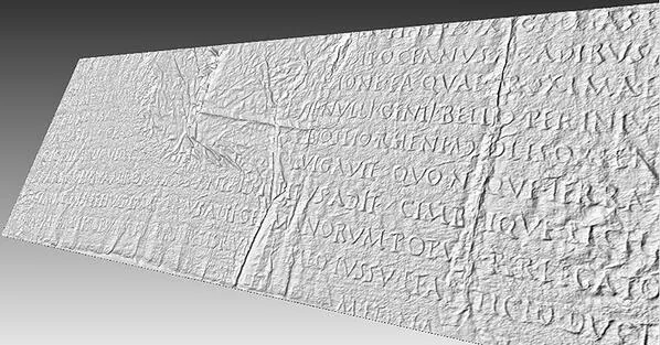 Grayscale 3D rendering of a long inscription with several lines of Latin capital letters.